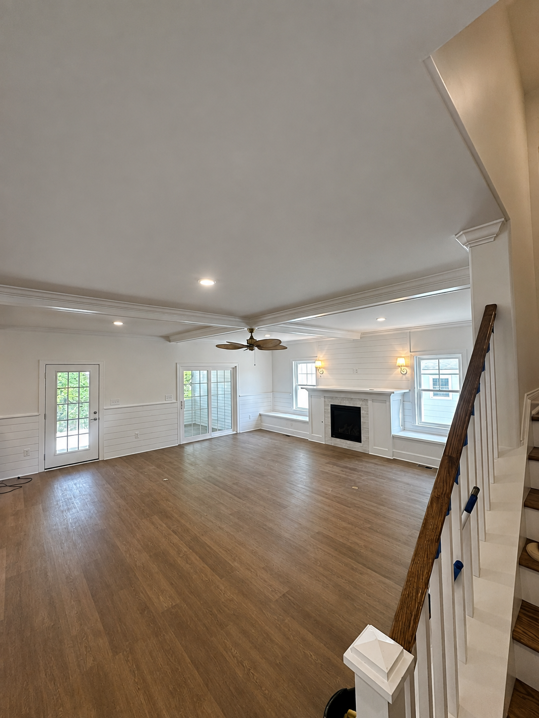 Completed great room with finished ceiling, walls, and fireplace