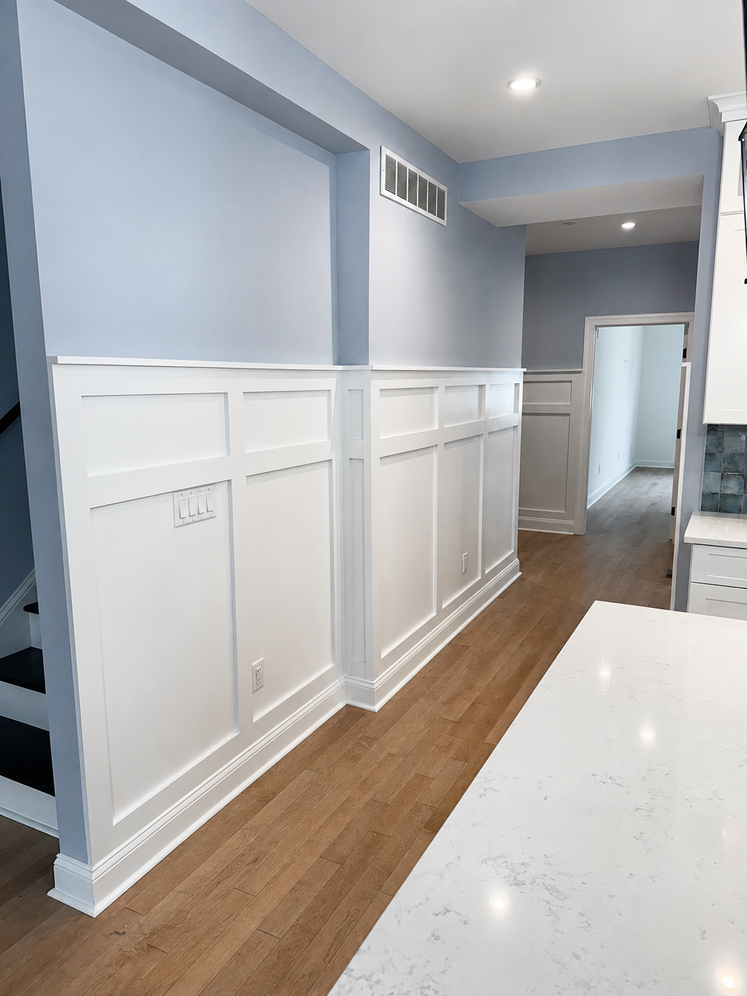 Completed hallway wall paneling with painted finish
