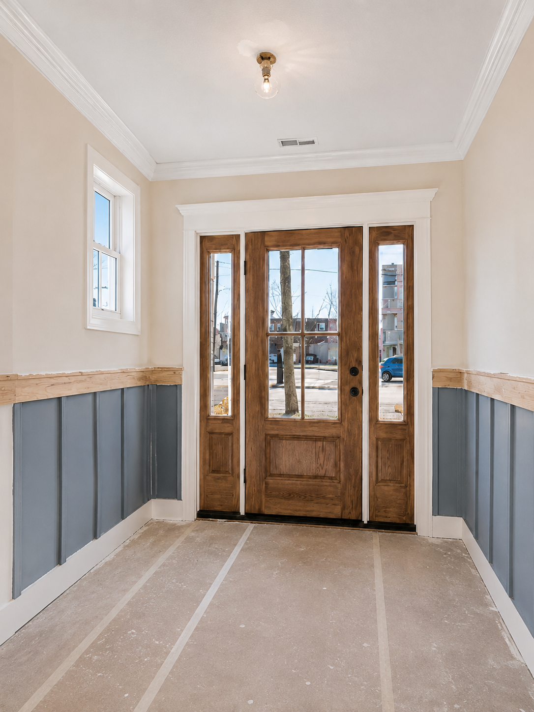 Completed custom foyer with paneling and entryway trim